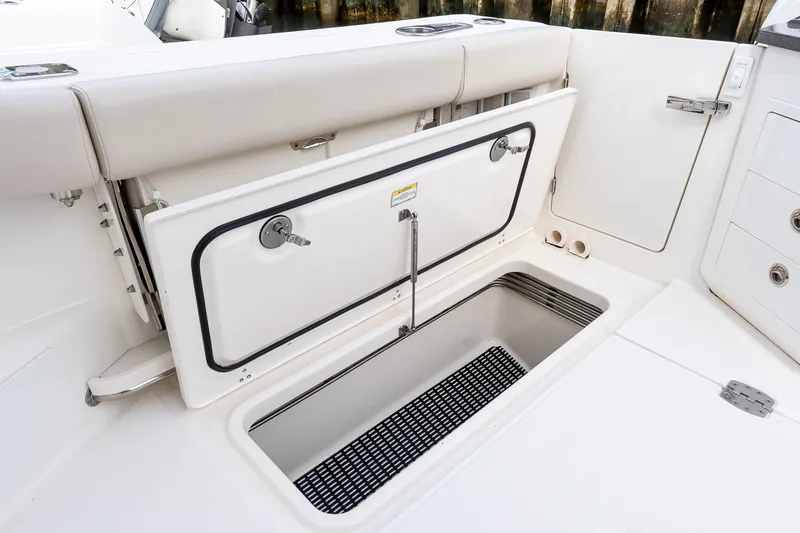 Slide: The Image of 2024 Boston Whaler 405 Conquest boat storage compartment with open hatch. - 20