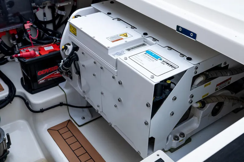 Slide: The Image of Engine compartment of 2024 Boston Whaler 405 Conquest, featuring Odyssey battery and generator. - 23