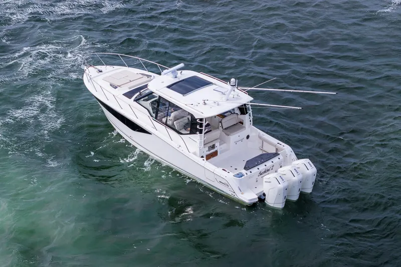 Slide: The Image of 2024 Boston Whaler 405 Conquest boat cruising on open water. - 8