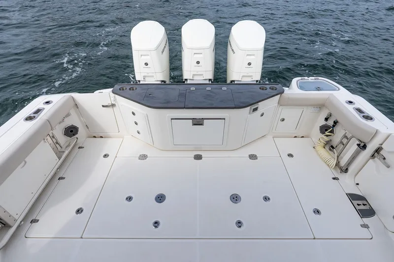 Slide: The Image of 2024 Boston Whaler 405 Conquest boat deck with four outboard engines. - 13
