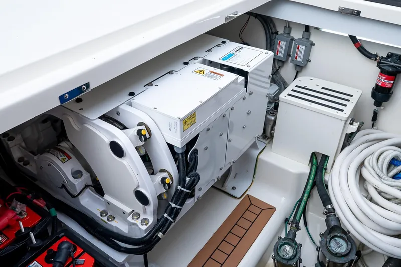 Slide: The Image of Engine compartment of 2024 Boston Whaler 405 Conquest, showcasing mechanical components and wiring. - 22