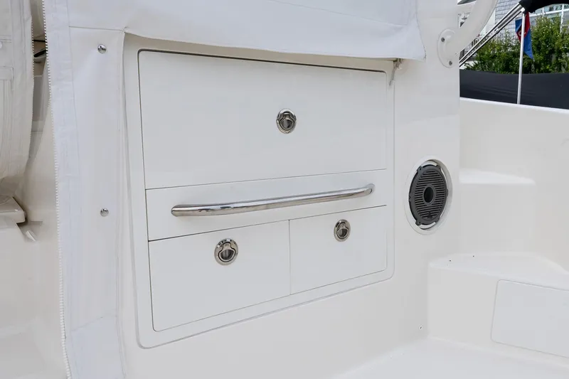 Slide: The Image of 2024 Boston Whaler 405 Conquest storage compartment with sleek design and integrated speaker. - 29