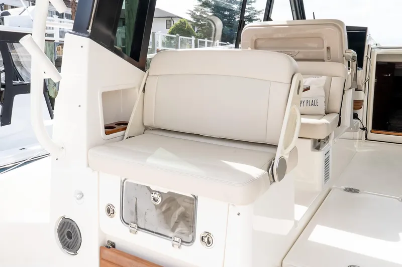 Slide: The Image of 2024 Boston Whaler 405 Conquest interior seating area with modern design and amenities. - 26