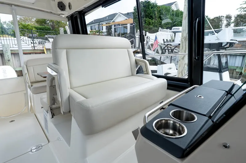 Slide: The Image of 2024 Boston Whaler 405 Conquest interior with plush seating and cup holders. - 44