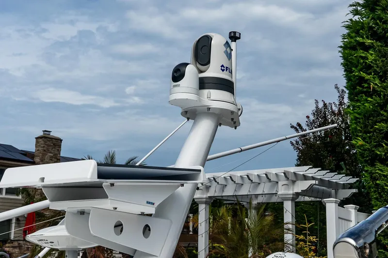 Slide: The Image of 2024 Boston Whaler 405 Conquest radar and camera system against a cloudy sky. - 62