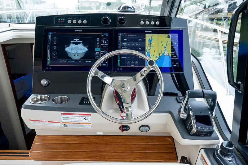 Slide: The Image of 2024 Boston Whaler 405 Conquest helm with dual Simrad displays and modern controls. - 41