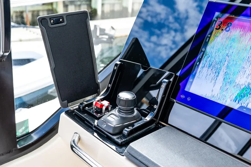 Slide: The Image of 2024 Boston Whaler 405 Conquest helm with joystick control and digital display. - 47