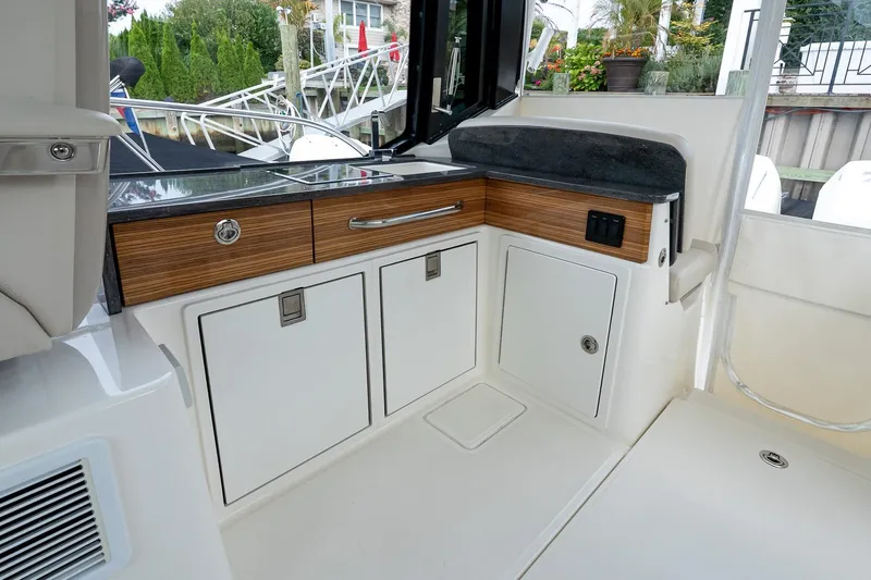 Slide: The Image of Interior view of 2024 Boston Whaler 405 Conquest boat, featuring sleek cabinetry and modern design. - 32