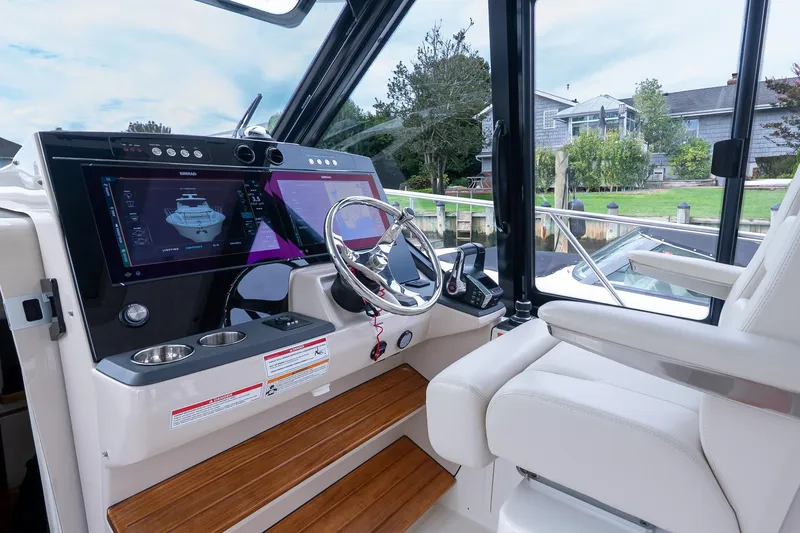 Slide: The Image of 2024 Boston Whaler 405 Conquest helm with advanced navigation displays and luxurious seating. - 40