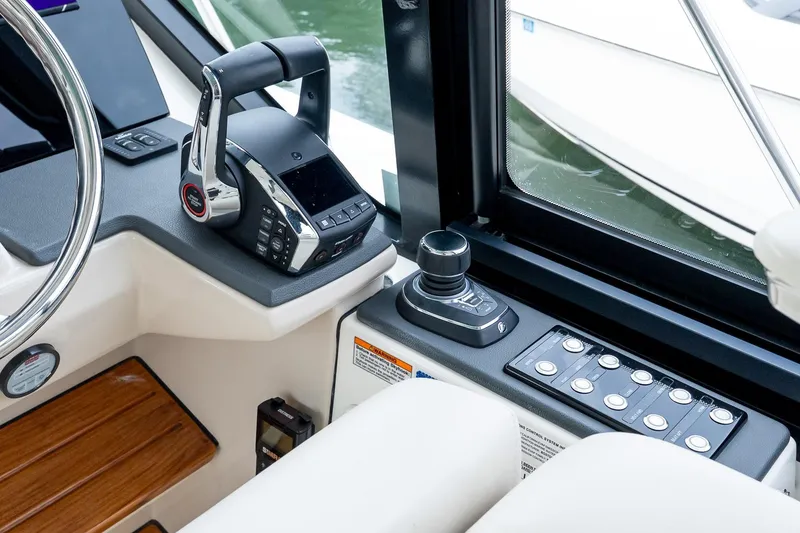 Slide: The Image of 2024 Boston Whaler 405 Conquest helm with advanced controls and joystick. - 42