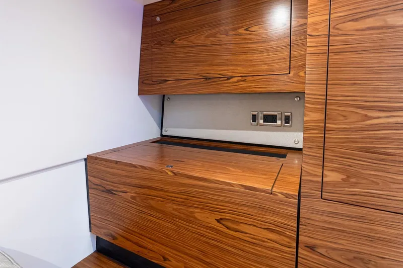 Slide: The Image of 2024 Boston Whaler 405 Conquest interior with sleek wooden cabinetry and modern electrical outlets. - 55