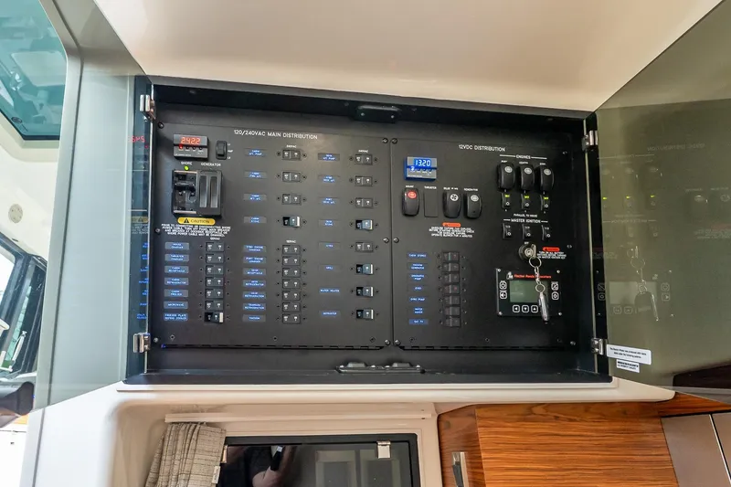 Slide: The Image of Electrical panel of 2024 Boston Whaler 405 Conquest boat, showcasing control systems. - 54