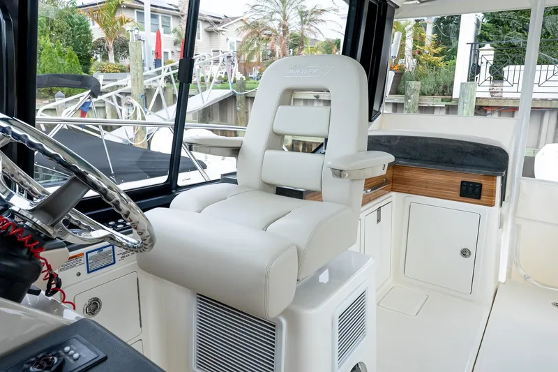 Slide: The Image of 2024 Boston Whaler 405 Conquest helm with luxurious seating and modern controls. - 39