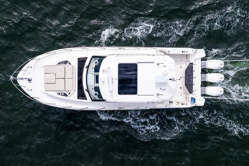Slide: The Image of Top view of 2024 Boston Whaler 405 Conquest yacht cruising on water. - 3