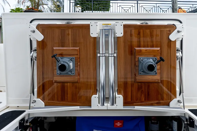 Slide: The Image of 2024 Boston Whaler 405 Conquest, featuring sleek wooden paneling and stainless steel accents. - 11