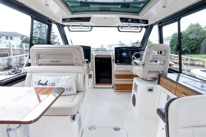 Slide: The Image of Luxurious interior of 2024 Boston Whaler 405 Conquest boat with modern helm and seating. - 30