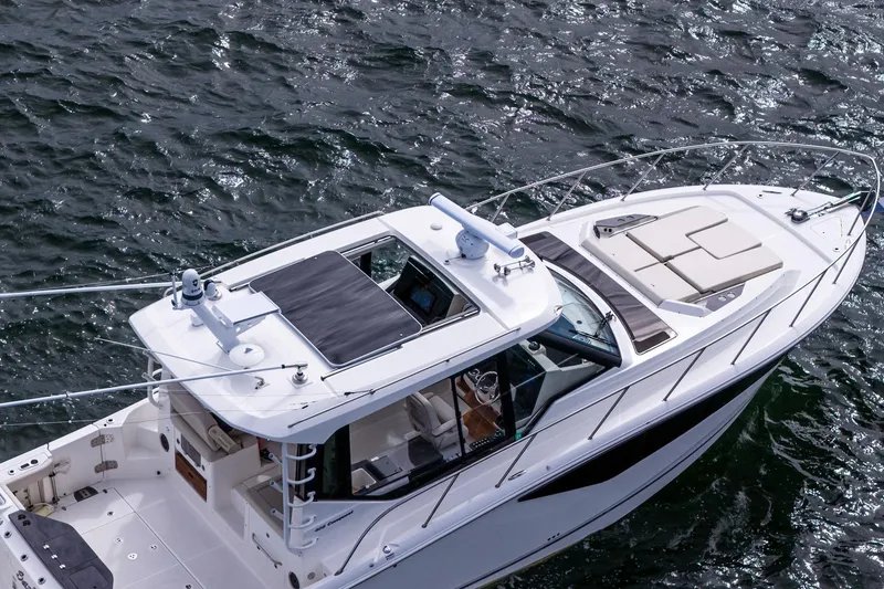 Slide: The Image of 2024 Boston Whaler 405 Conquest boat on water, aerial view of deck and cabin. - 2