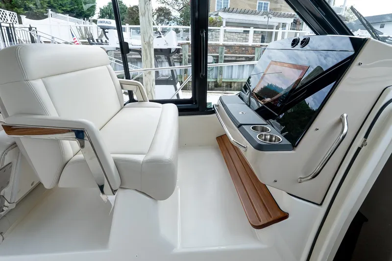 Slide: The Image of 2024 Boston Whaler 405 Conquest helm with luxurious seating and modern controls. - 45