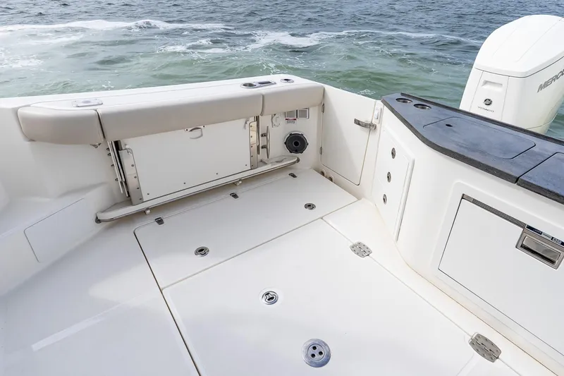 Slide: The Image of 2024 Boston Whaler 405 Conquest boat deck with seating and storage, ocean view. - 19