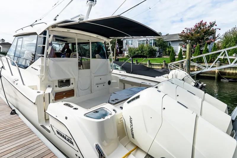 Slide: The Image of 2024 Boston Whaler 405 Conquest docked, showcasing sleek design and powerful Mercury engines. - 24