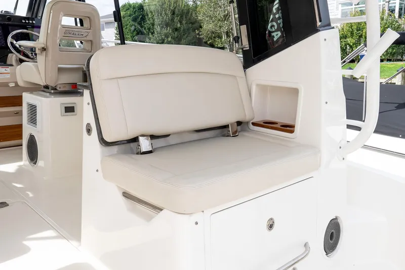 Slide: The Image of 2024 Boston Whaler 405 Conquest interior seating with storage and cup holders. - 27