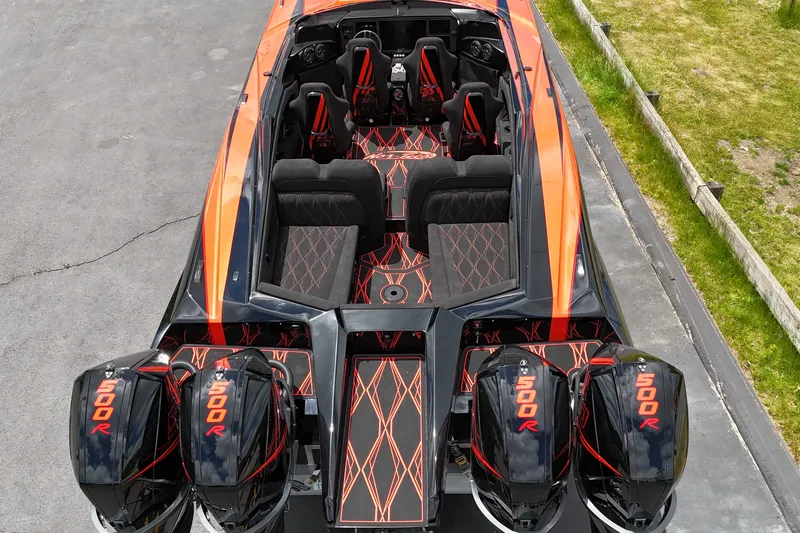 Slide: The Image of 2027 Nor-Tech 4000 Roadster with quad 500R engines, sleek orange and black design. - 9
