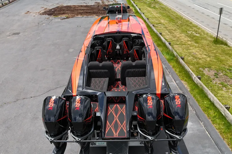 Slide: The Image of 2027 Nor-Tech 4000 Roadster with quad 500R engines, vibrant orange and black design. - 6