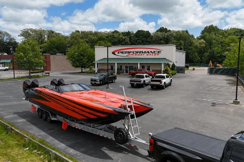 Slide: The Image of Nor-Tech 4000 Roadster 2027 at Performance Boat Sales dealership, vibrant orange and black design. - 8