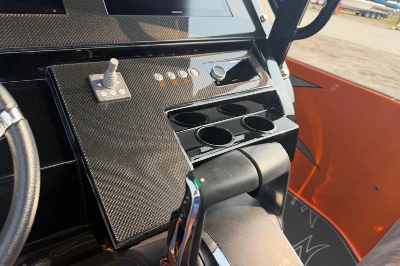 Slide: The Image of 2024 Donzi 39 VRZ boat dashboard with joystick controls and cup holders. - 24
