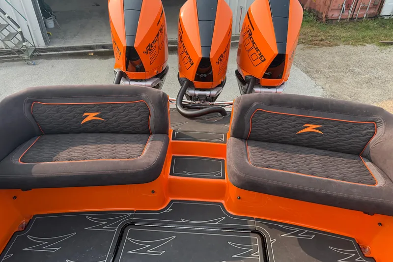 Slide: The Image of 2024 Donzi 39 VRZ boat with triple orange outboard engines and cushioned seating. - 20