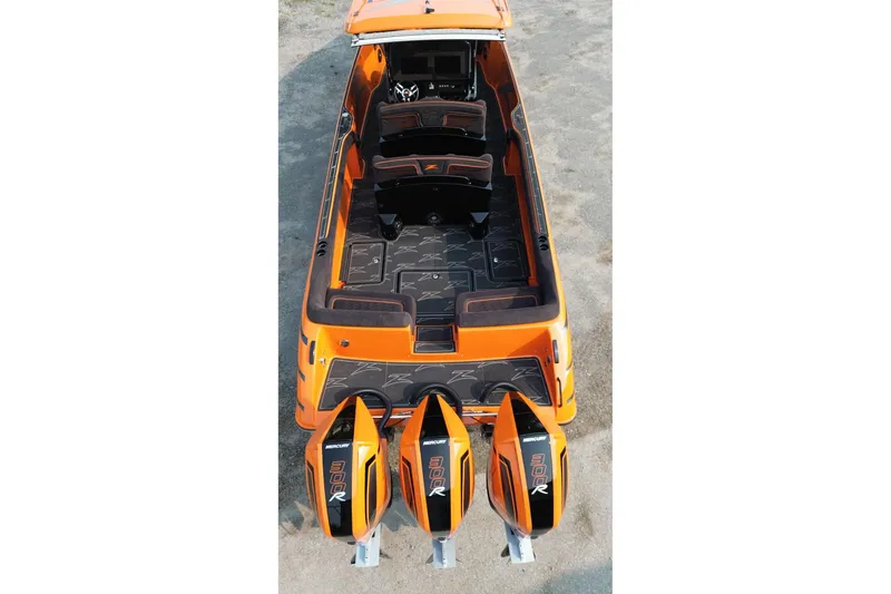 Slide: The Image of 2024 Donzi 39 VRZ boat with triple Mercury 300R engines, orange exterior, and spacious interior. - 60