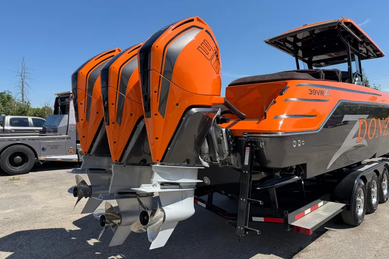 Slide: The Image of 2024 Donzi 39 VRZ boat with triple outboard engines, vibrant orange and gray design. - 13
