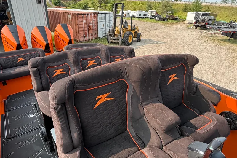Slide: The Image of 2024 Donzi 39 VRZ boat interior with plush seating and vibrant orange accents. - 41