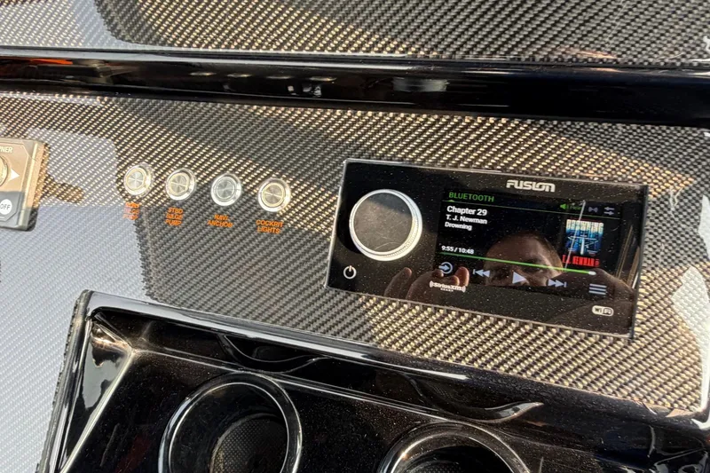 Slide: The Image of 2024 Donzi 39 VRZ dashboard with Fusion Bluetooth audio system and carbon fiber finish. - 39