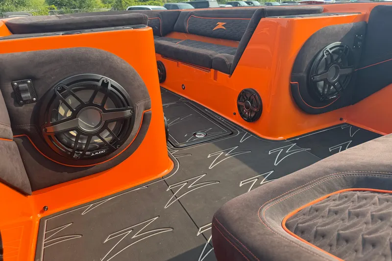 Slide: The Image of 2024 Donzi 39 VRZ interior with vibrant orange accents and premium audio system. - 27