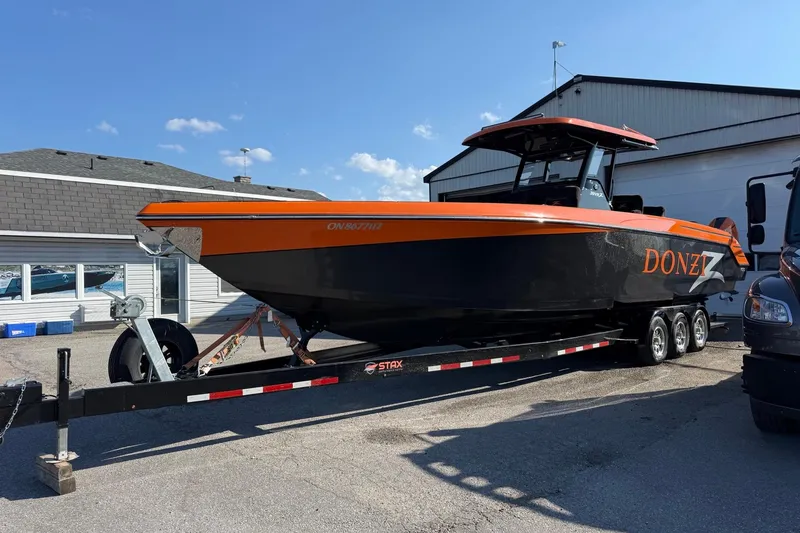 Slide: The Image of 2024 Donzi 39 VRZ boat on trailer, featuring sleek orange and black design. - 7