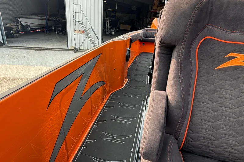 Slide: The Image of 2024 Donzi 39 VRZ boat interior with orange accents and sleek seating design. - 37