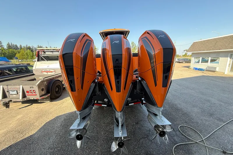 Slide: The Image of 2024 Donzi 39 VRZ boat with three powerful orange outboard motors. - 5