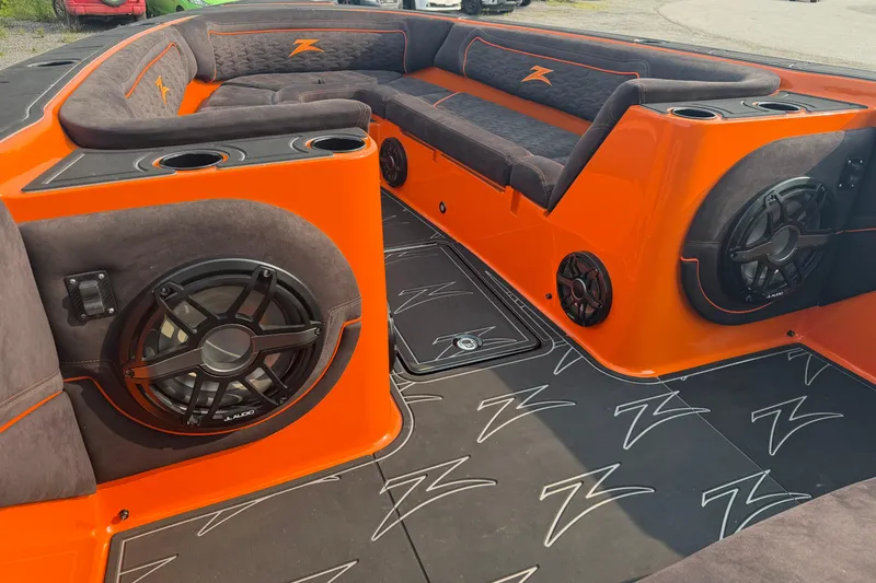 Slide: The Image of 2024 Donzi 39 VRZ boat interior with orange and black seating, speakers, and cup holders. - 28