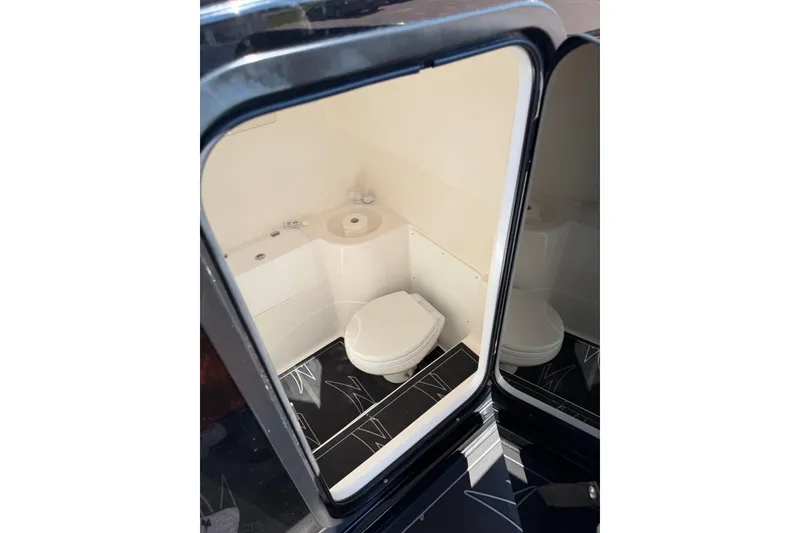 Slide: The Image of 2024 Donzi 39 VRZ boat interior bathroom with modern amenities and sleek design. - 9