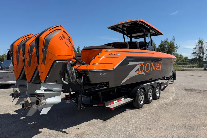 Slide: The Image of 2024 Donzi 39 VRZ boat with triple outboard engines, vibrant orange and gray design. - 14