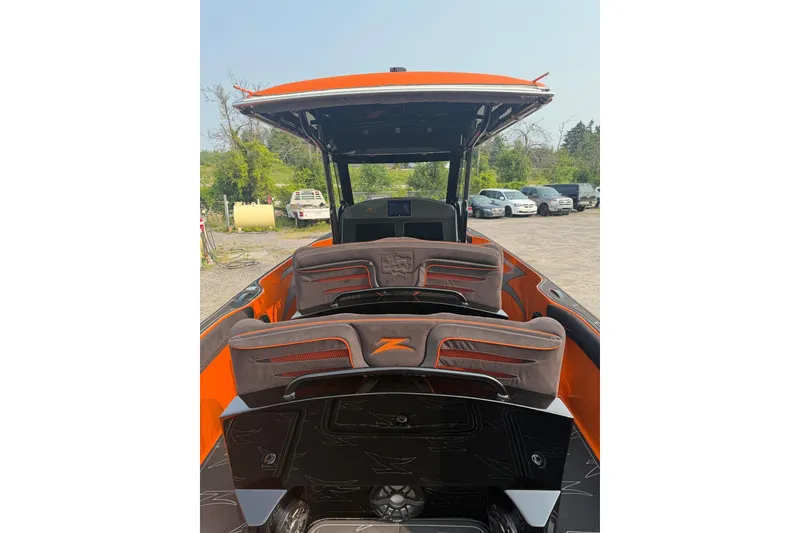 Slide: The Image of 2024 Donzi 39 VRZ boat interior with orange accents and sleek seating design. - 18