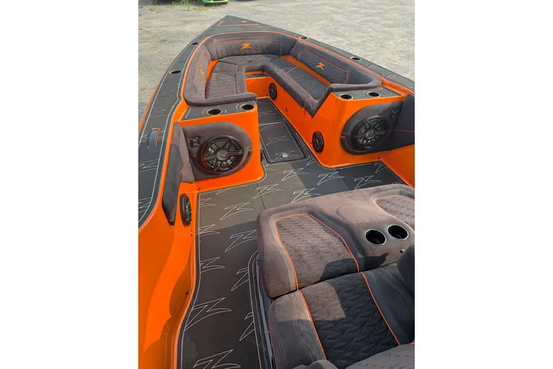 Slide: The Image of 2024 Donzi 39 VRZ boat interior with orange and black seating and speakers. - 26