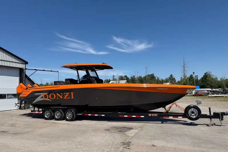 Slide: The Image of 2024 Donzi 39 VRZ boat on trailer, featuring sleek black and orange design. - 15