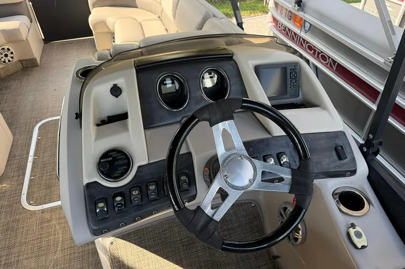 Slide: The Image of 2016 Bennington 2550 RBR boat dashboard with steering wheel and control panel. - 7
