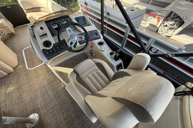 Slide: The Image of Interior of a 2016 Bennington 2550 RBR pontoon boat with plush seating and modern controls. - 6