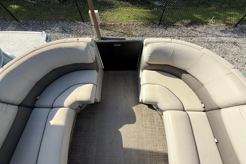 Slide: The Image of 2016 Bennington 2550 RBR boat interior with beige seating and carpeted floor. - 10