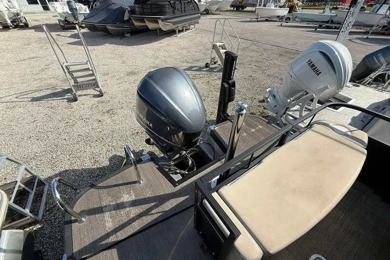 Slide: The Image of 2016 Bennington 2550 RBR boat with Yamaha outboard motors in a marina setting. - 2