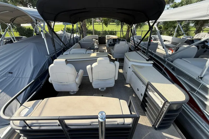 Slide: The Image of 2016 Bennington 2550 RBR pontoon boat interior with seating and helm under canopy. - 3