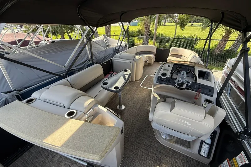 Slide: The Image of Interior of a 2016 Bennington 2550 RBR pontoon boat with luxurious seating and helm. - 4